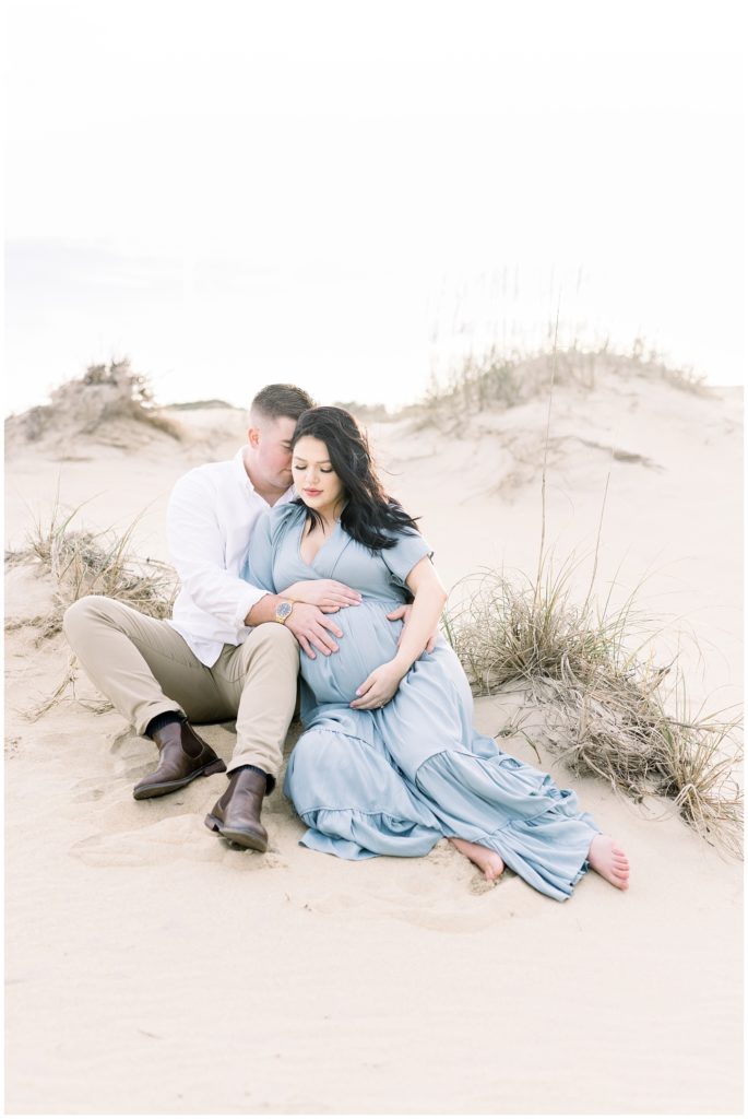 expectant couple in the sand dunes

