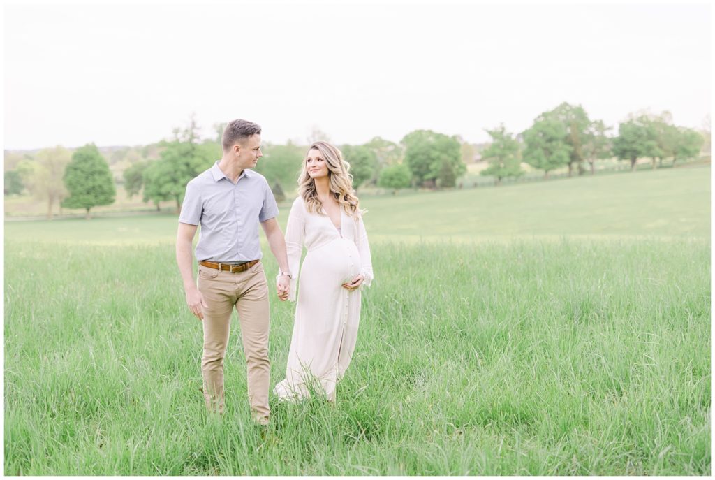 pregnant woman and her husband in a field
