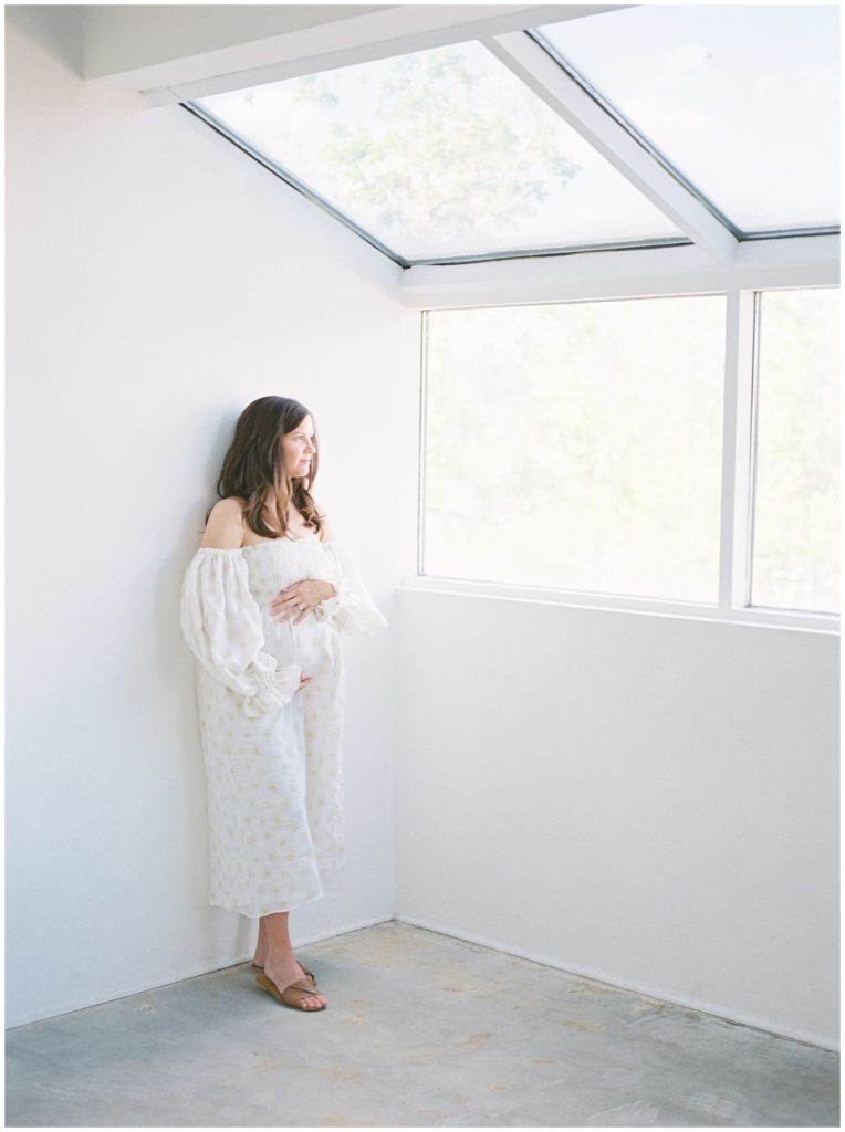 pregnant woman looking out the window
