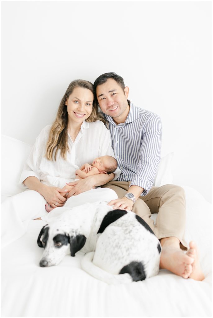 young family witn newborn and dog 
