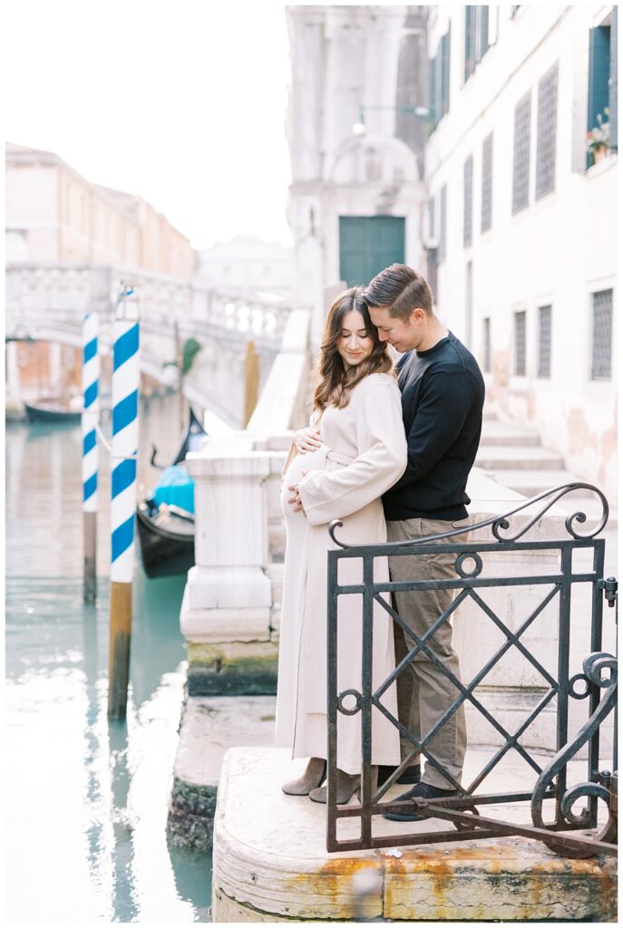 expectant couple in front of Bridge of Signs during their Venice babymoon