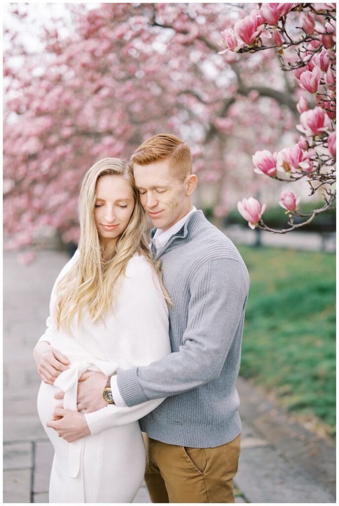 stuttgart maternity photographer photographs couple with magnolia blooms

