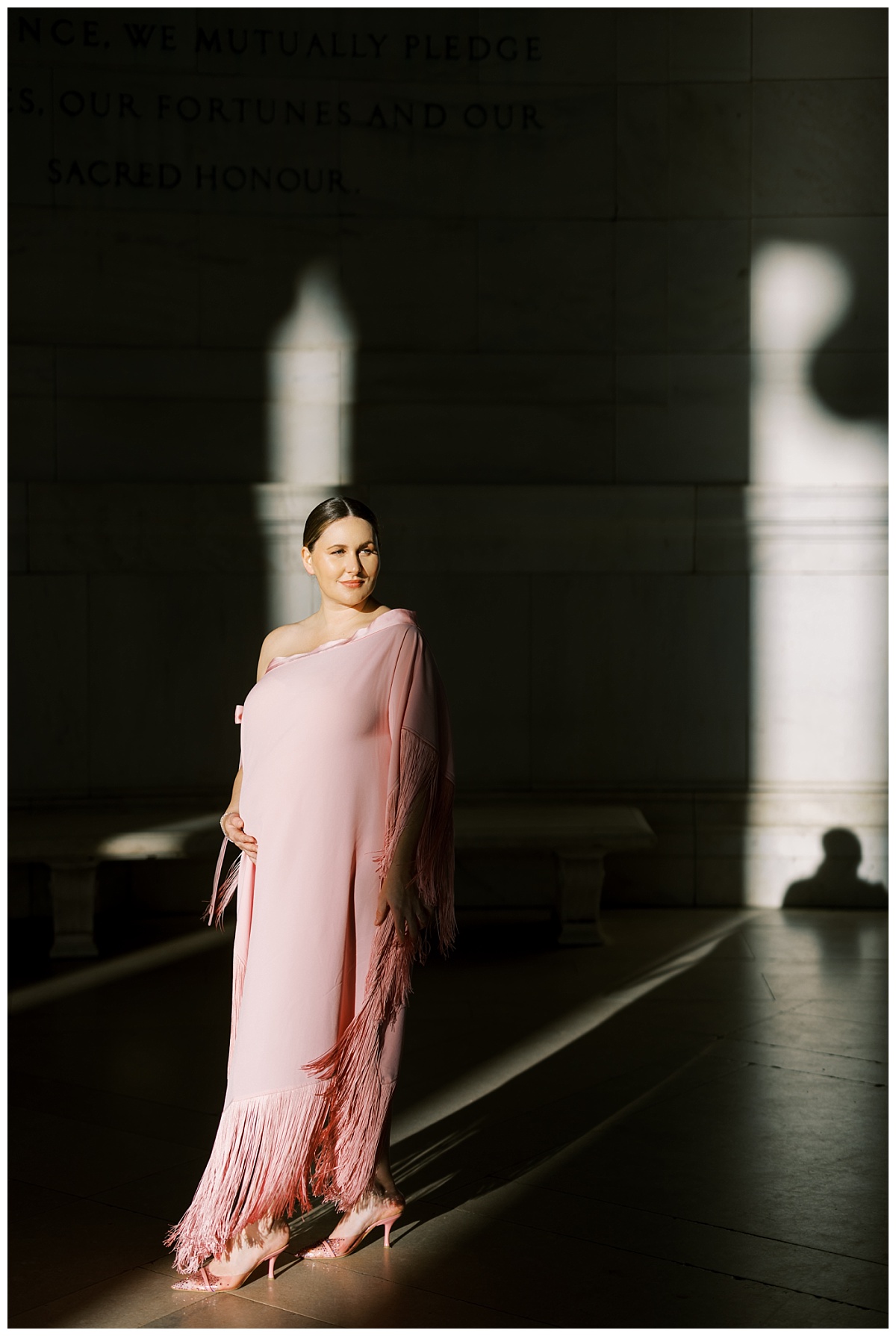 pregnant woman in pink designer dress