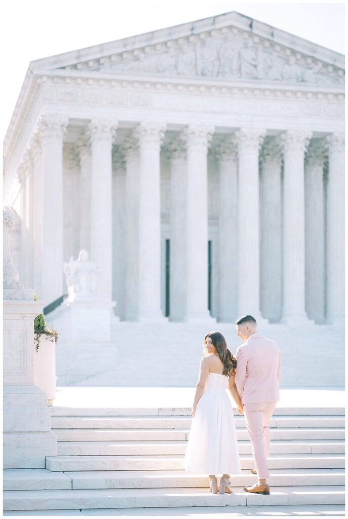 engaged couple on marble steps
