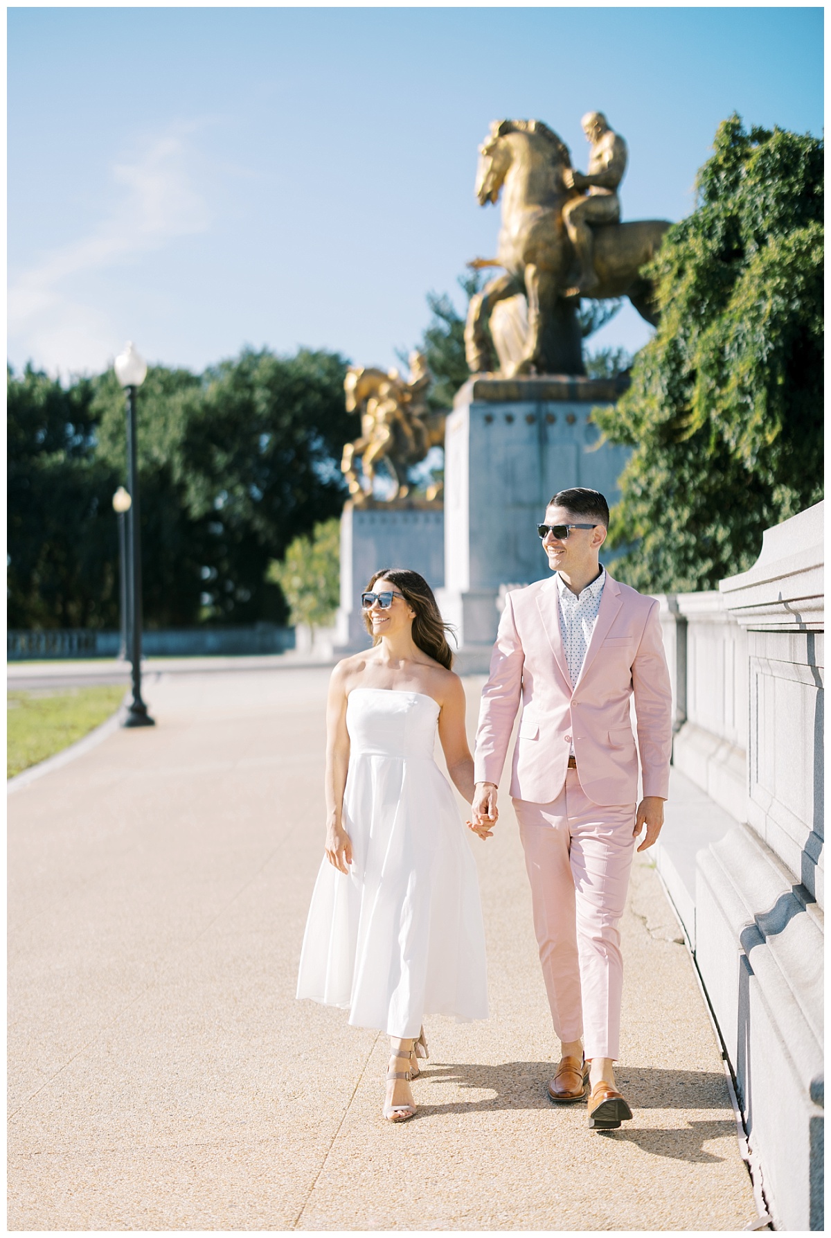 engaged couple walking on the sidewalk